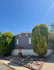 View of property exterior with an attached carport