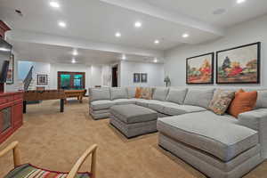 Living area with recessed lighting, pool table, light carpet, and stairway