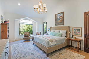 Bedroom with light carpet, vaulted ceiling, a chandelier, and recessed lighting