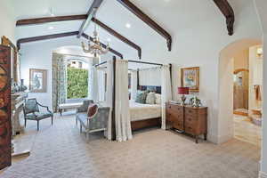 Bedroom with arched walkways, a chandelier, and recessed lighting