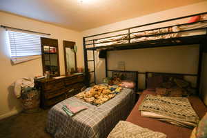 Bedroom with carpet and a textured ceiling