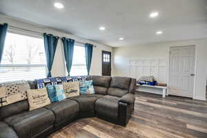 Living area with wood finished floors, recessed lighting, and a textured ceiling