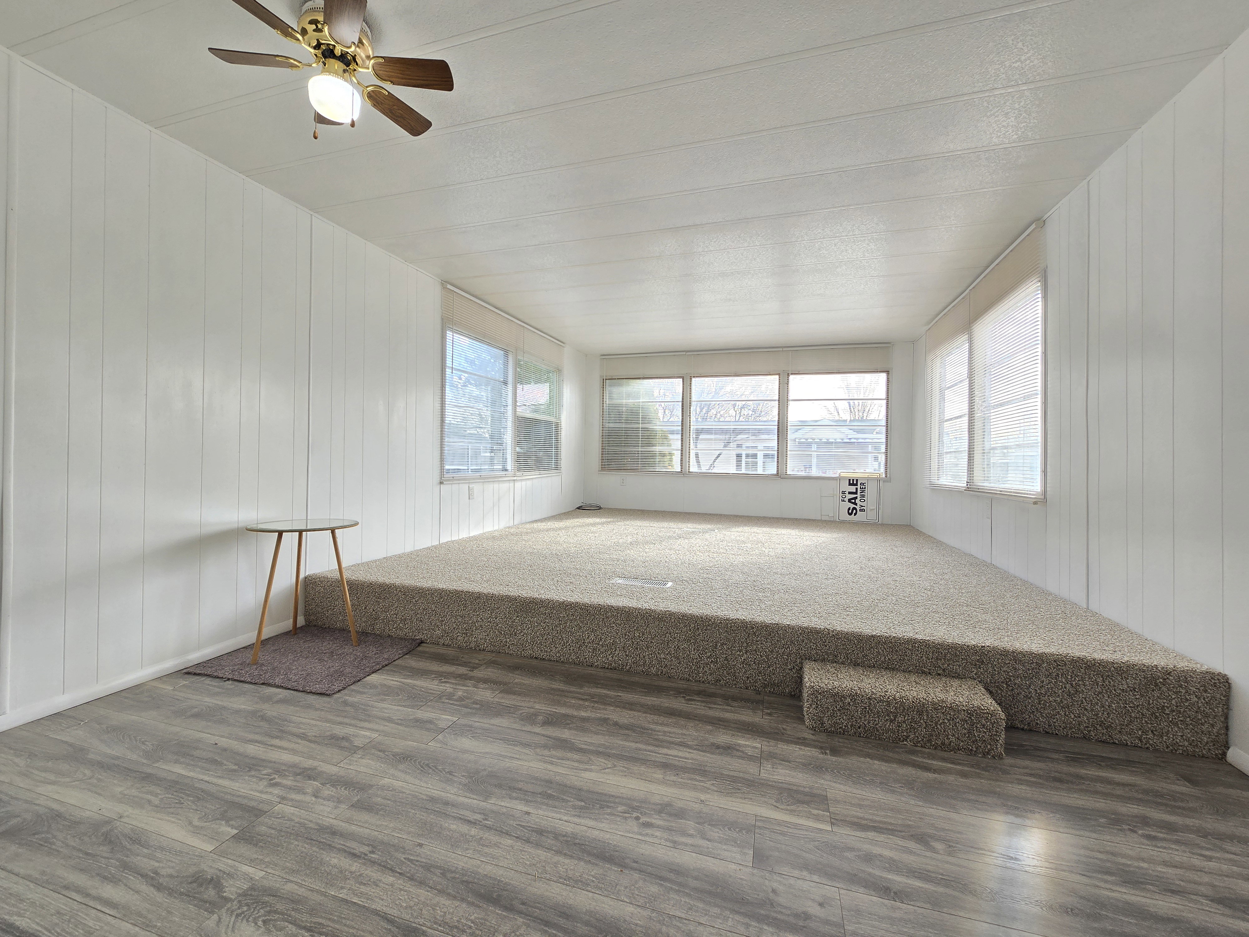Unfurnished sunroom featuring wooden walls and wood finished floors