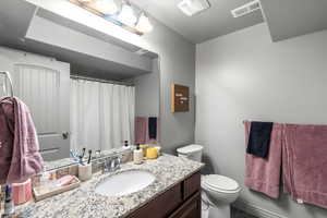 Bathroom with a shower with shower curtain, vanity, and tile patterned flooring