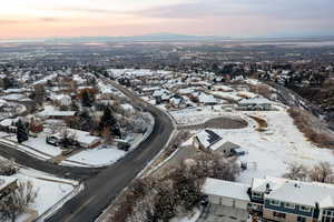 Snowy aerial view with a residential view and a mountain view
