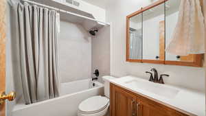 Full Downstairs bathroom with shower / bath combo and vanity