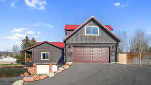 View from side. With 2 single car and 1 double wide 2 car garage, asphalt driveway