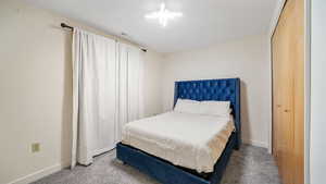 Downstairs bedroom#1. Carpeted bedroom with a closet.