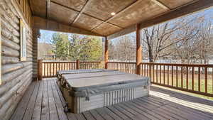 Backyard Wooden deck featuring a hot tub