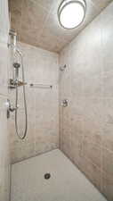 Full bathroom with a tile shower