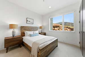 Bedroom with light colored carpet