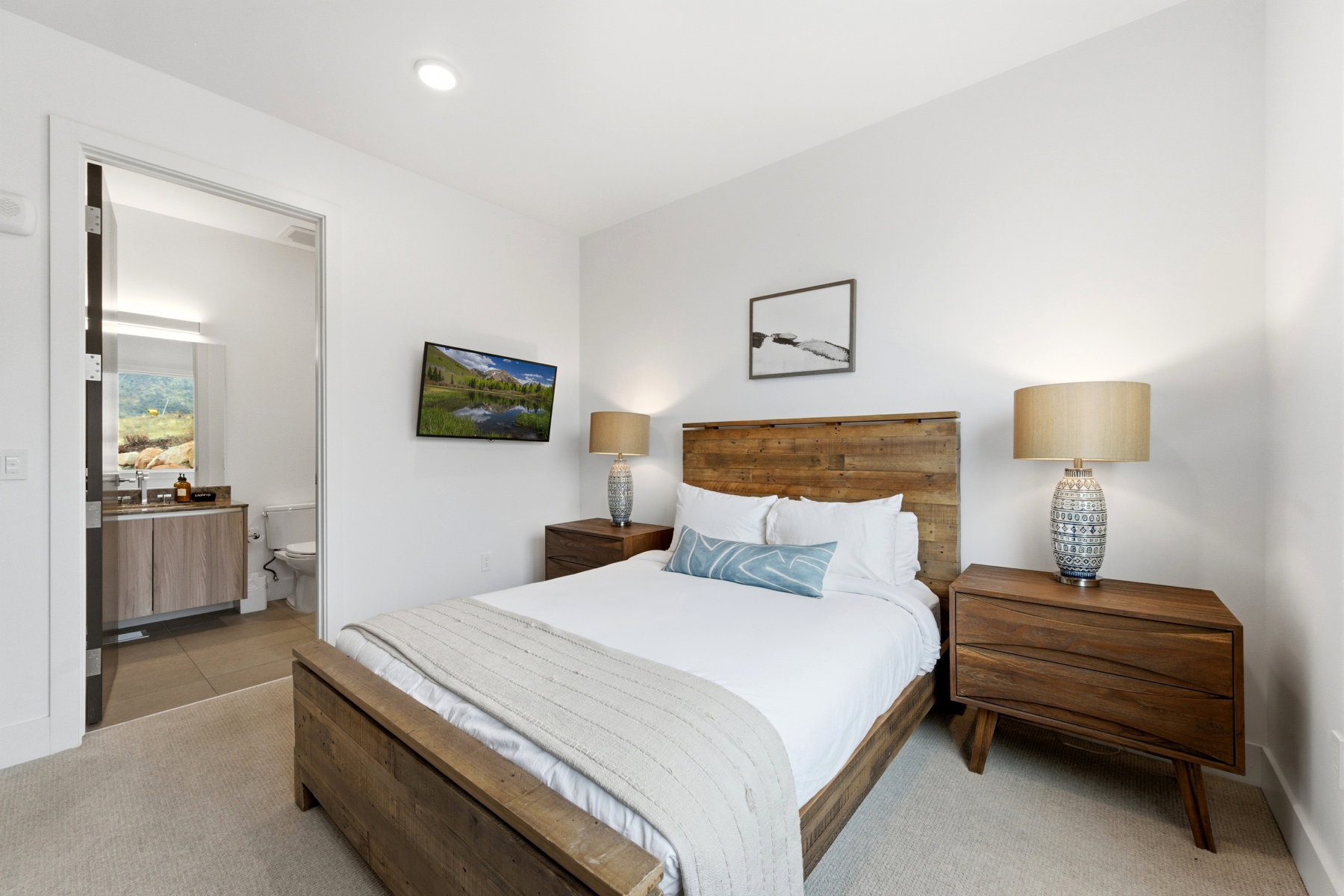 Bedroom with carpet and connected bathroom