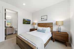 Bedroom with carpet and connected bathroom