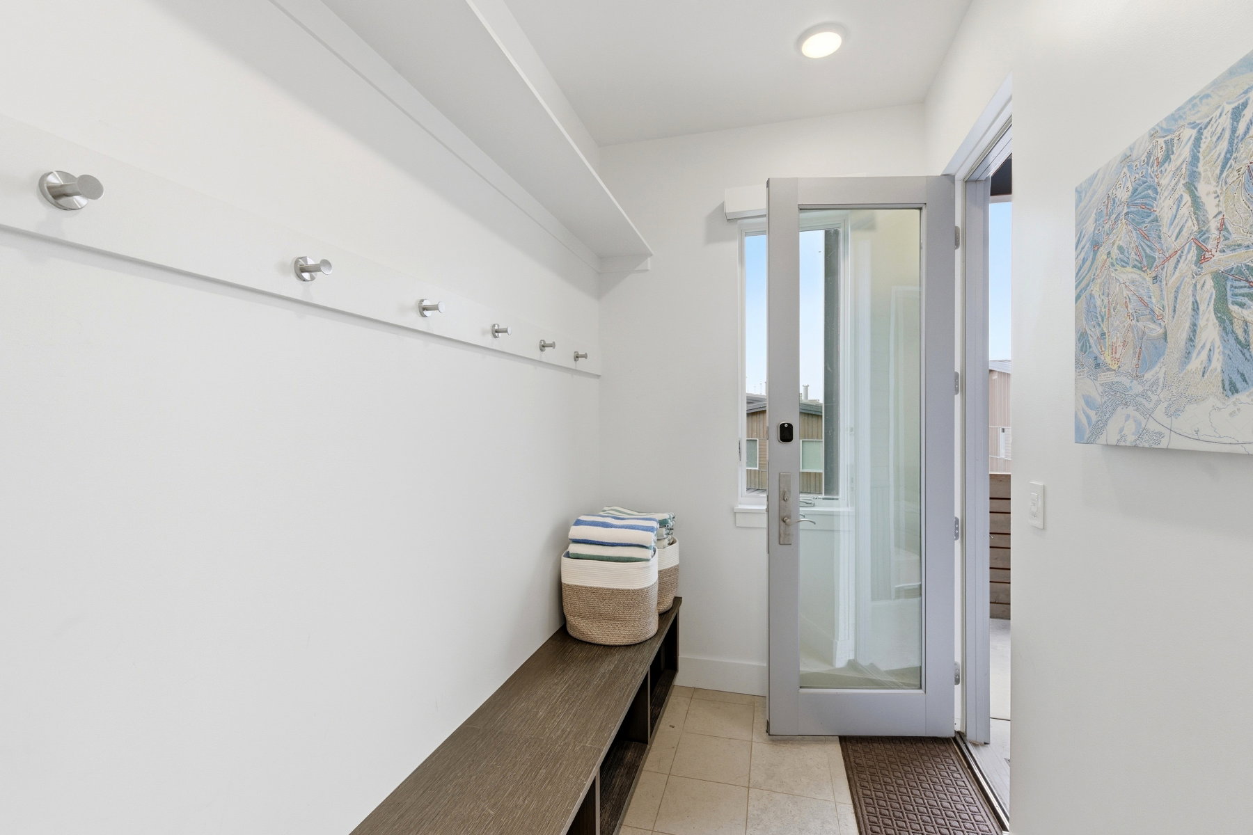 Mudroom with light tile patterned flooring and baseboards