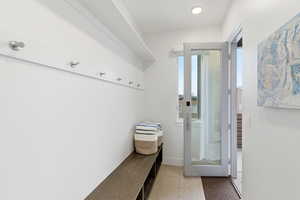 Mudroom with light tile patterned flooring and baseboards