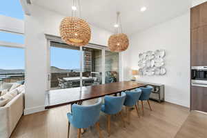 Dining area featuring light wood-style floors, a chandelier, a mountain view, and recessed lighting