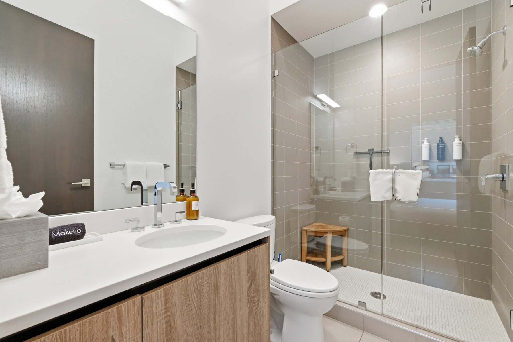 Full bathroom featuring vanity and a shower stall
