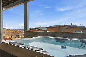 View of swimming pool with a hot tub