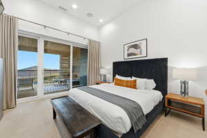 Bedroom with light colored carpet and access to exterior