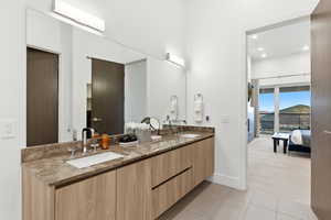 Full bath featuring double vanity, light colored carpet, connected bathroom, recessed lighting, and light tile patterned floors