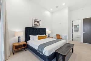 Bedroom with carpet, ensuite bathroom, and recessed lighting