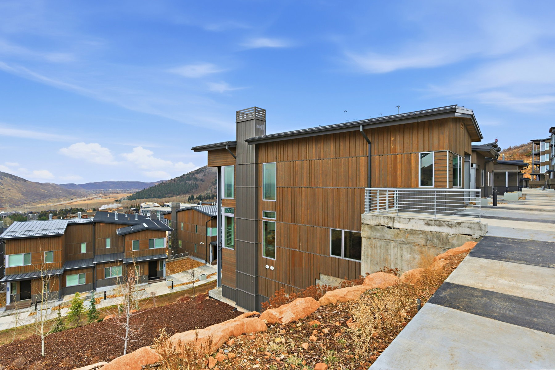 View of side of property featuring a mountain view and a chimney