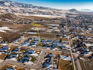 Aerial overview of property's location featuring nearby suburban area and mountains