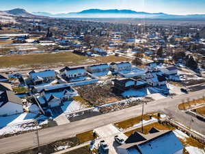 Snowy aerial view with a residential view and a mountain view