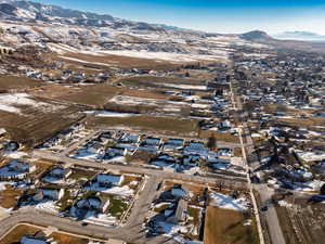 Snowy aerial view with a residential view and a mountain view
