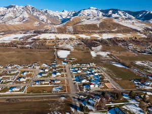 Snowy aerial view featuring a residential view and a mountain view