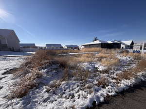 Yard covered in snow with a residential view
