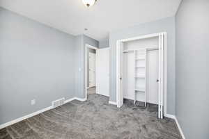Unfurnished bedroom featuring carpet flooring and a closet