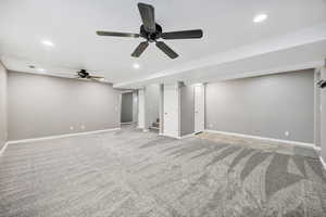 Unfurnished living room with ceiling fan, recessed lighting, stairway, and light carpet