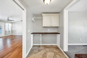 Laundry room /corridor with baseboards and a textured ceiling
