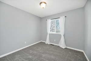 Unfurnished bedroom with baseboards and carpet