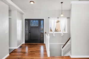 Entry way featuring hardwood / wood-style flooring and baseboards