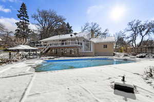 View of swimming pool with a patio area, stairway, and a deck
