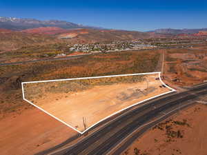 Aerial view of property's location with a mountainous background and property parcel outlined