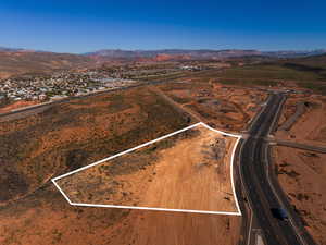 Overview of rural landscape featuring a mountainous background and property parcel outlined