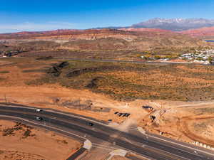 Aerial view of property and surrounding area featuring a mountainous background