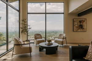 Living area with wood finished floors and baseboards