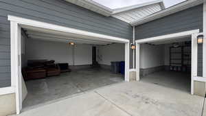 Garage featuring concrete driveway