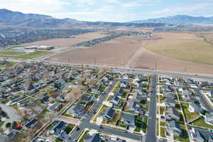 Aerial view of property's location with nearby suburban area and mountains