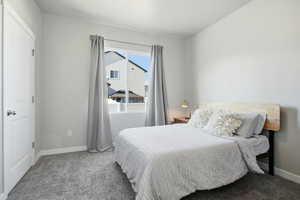 Carpeted bedroom with baseboards