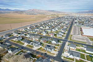 Aerial view of property's location with nearby suburban area and a mountainous background