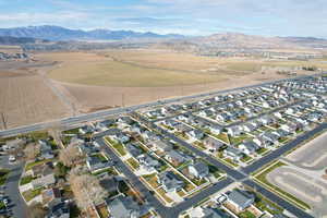 Aerial view of property's location with a mountain backdrop and nearby suburban area