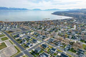 Aerial overview of property's location featuring a water and mountain view and nearby suburban area