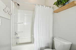 Bathroom with shower / bath combo and toilet