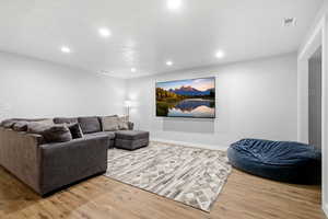 Living area featuring recessed lighting and light wood-type flooring