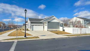 View of front facade with concrete driveway, an attached garage, and a residential view